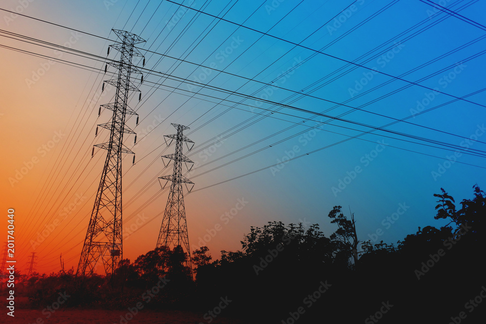 Fototapeta premium High Voltage Poles on the orange sky Concept of electric power