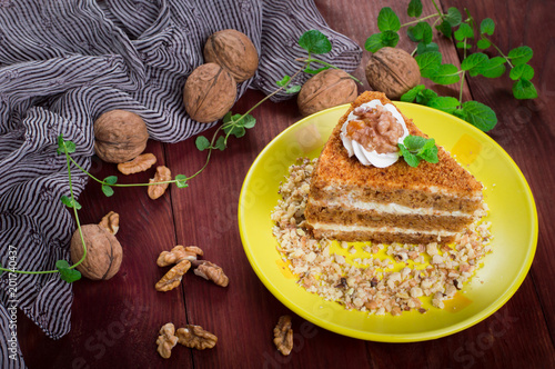 Honey cake on a plate. Wooden rustic background