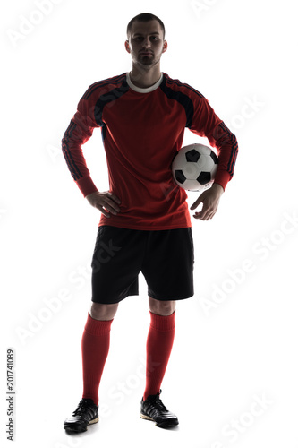 Fototapeta Naklejka Na Ścianę i Meble -  silhouette of young player with soccer ball in hands isolated on white background