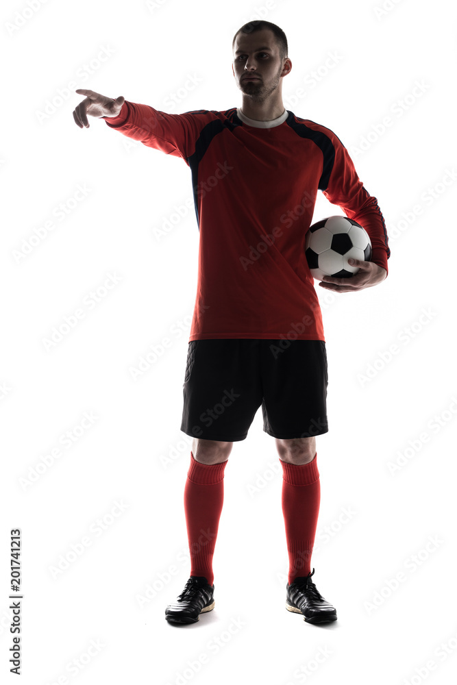 silhouette of young player pointed with finger with soccer ball in hands isolated on white background