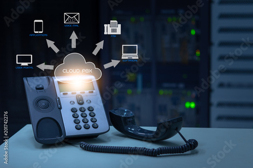 IP Telephony cloud pbx concept, telephone device with illustration icon of voip services and networking data center on background photo