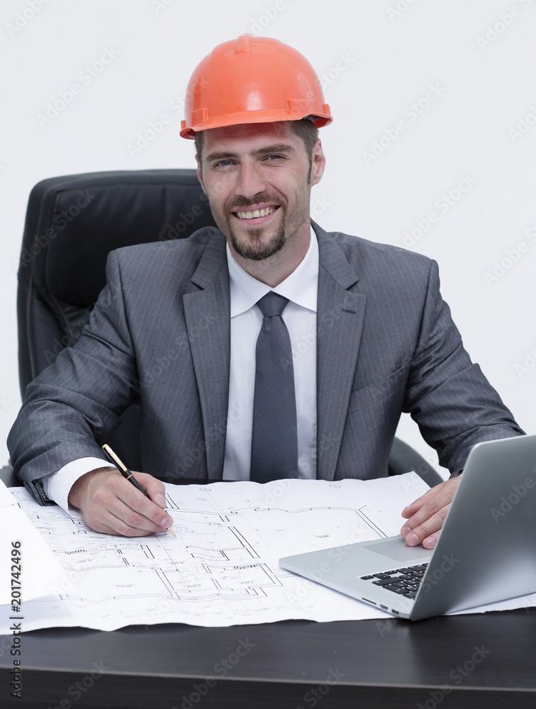 engineer is studying the draft,sitting behind a Desk engineer is studying the draft,sitting behind a Desk