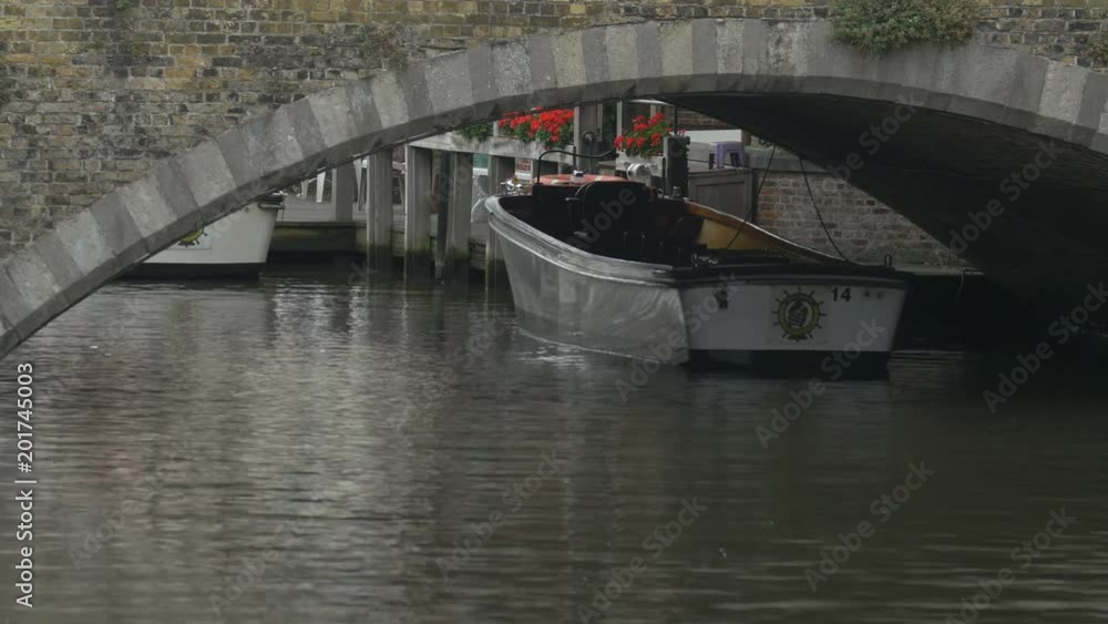 Moored boats under the bridge of Dijver Canal Moored boats under the bridge of Dijver Canal