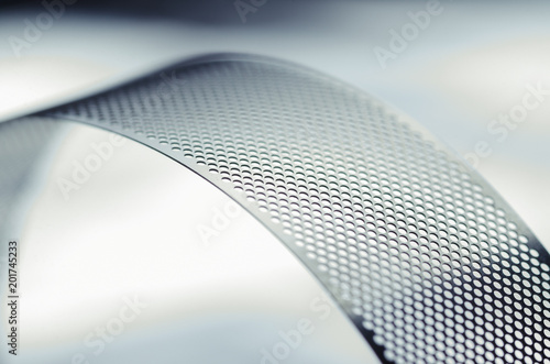 Metal perforated tape, close-up abstract