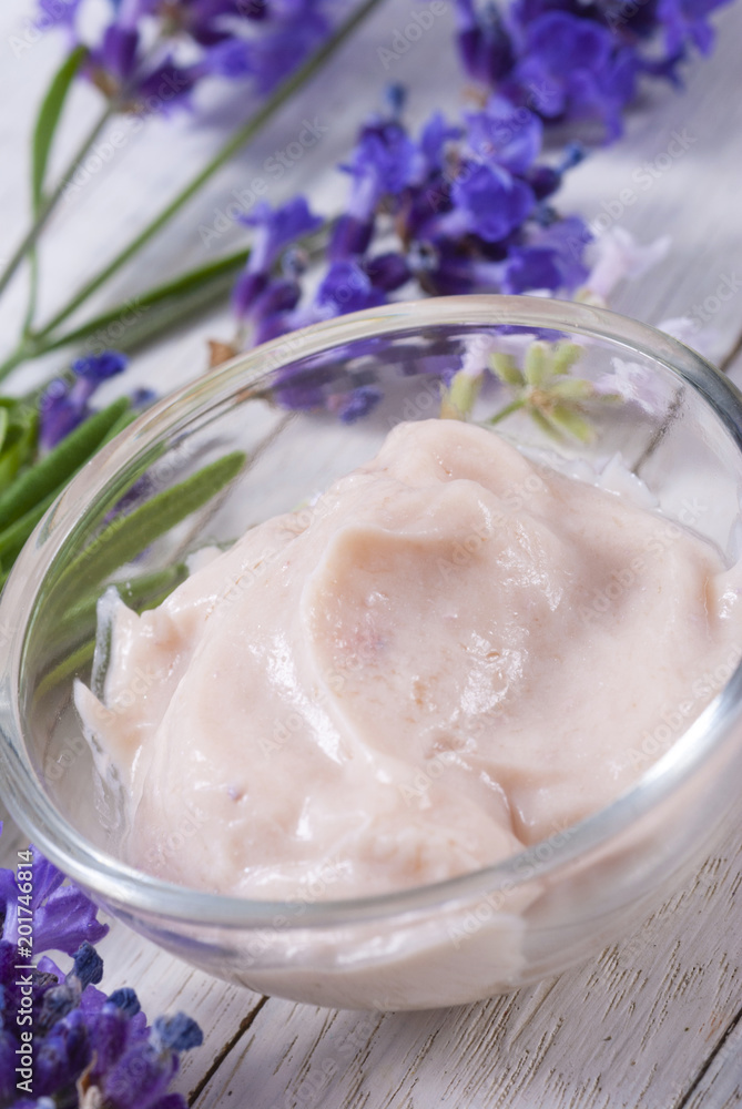 cosmetic cream and lavender flowers on white wood table background cosmetic cream and lavender flowers on white wood table background