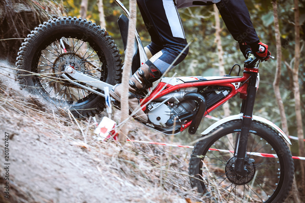 Fototapeta premium Trials motorcycle while competition in nature park, close up shot