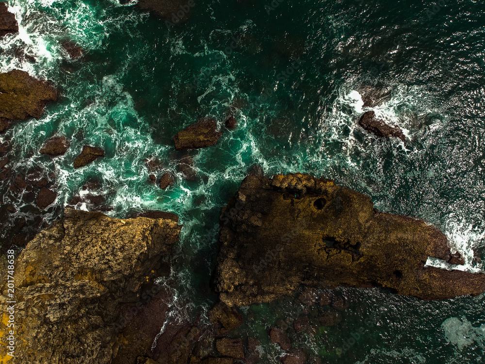 Aerial view of sea waves crash on the shoreline. Portuguese coastline