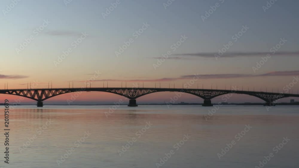 Time lapse. Dawn on the Volga river. Road bridge between the cities of Saratov and Engels, Russia. Early April morning. Time lapse. Dawn on the Volga river. Road bridge between the cities of Saratov and Engels, Russia. Early April morning.