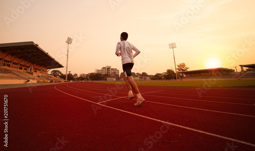 Athlete runs around the stadium in the morning