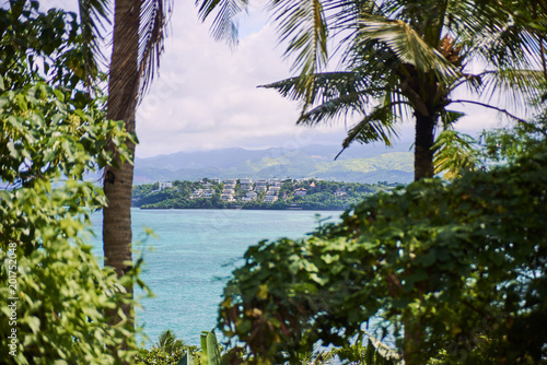 Beautiful blue lagoon view through the palm trees