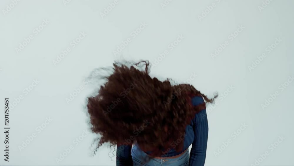 woman with long curly hair dancing and shaking hair and smiling. Have fun shaking head woman with long curly hair dancing and shaking hair and smiling. Have fun shaking head