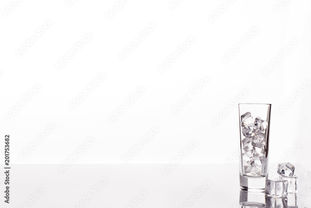 glass with ice cubes on white background glass with ice cubes on white background