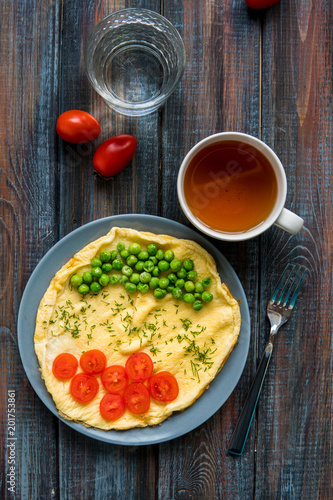 Omelette with green peas and cherry tomatoes. Protein breakfast