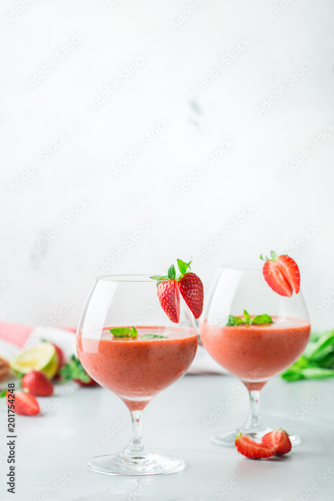 Alcohol cocktail with vodka, strawberry, lime, basil and ice Alcohol cocktail with vodka, strawberry, lime, basil and ice