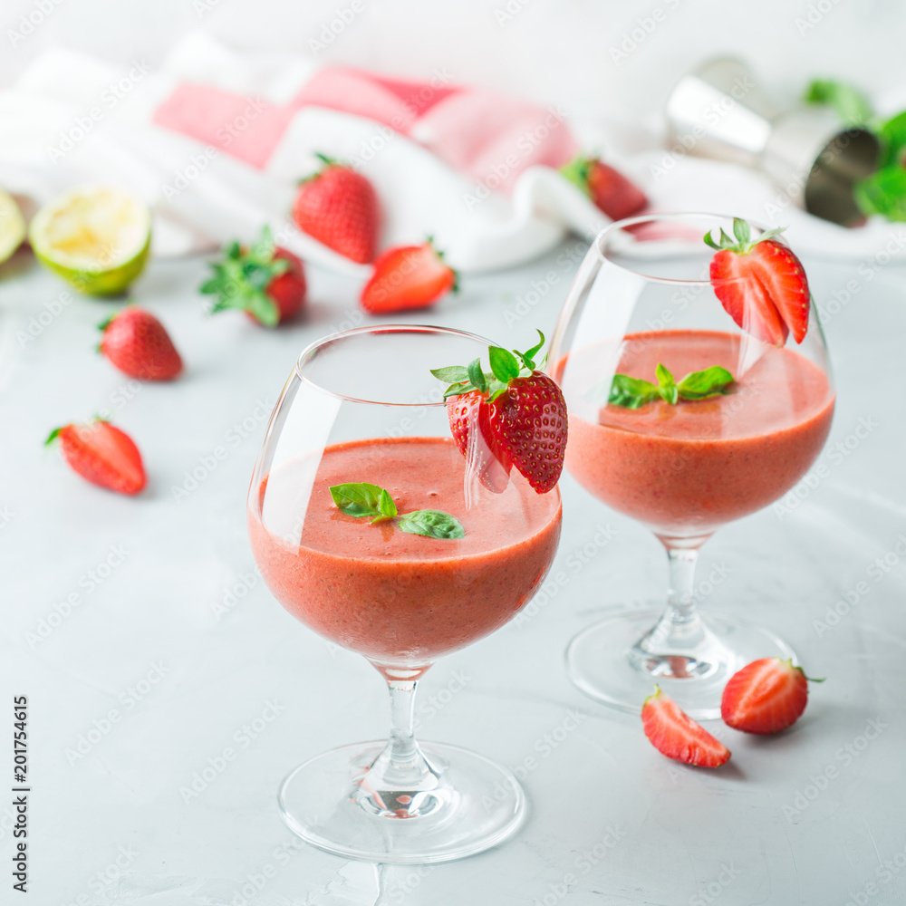 Alcohol cocktail with vodka, strawberry, lime, basil and ice Alcohol cocktail with vodka, strawberry, lime, basil and ice