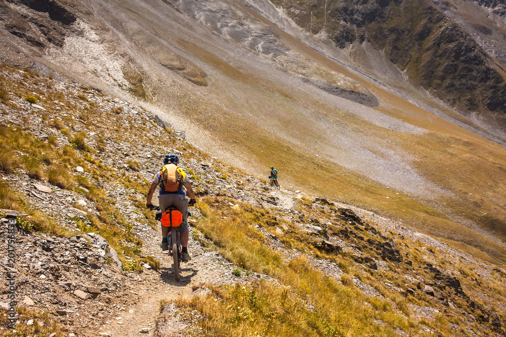 Mountain bikers are travelling in the highlands of Tusheti region, Georgia Mountain bikers are travelling in the highlands of Tusheti region, Georgia