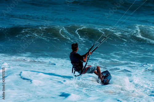 Kitesurfer on a beautiful background of spray during the sunset