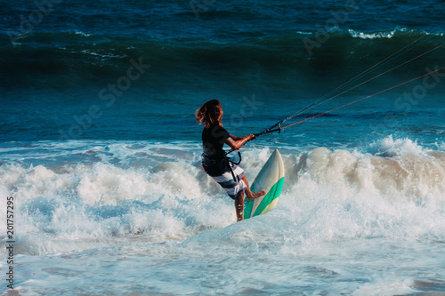 Kitesurfer jumping on a beautiful background of spray during the sunset