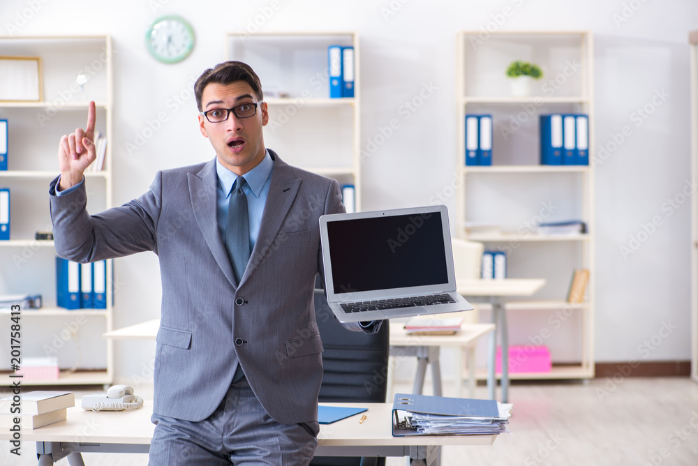 Young handsome businessman employee working in office at desk Young handsome businessman employee working in office at desk