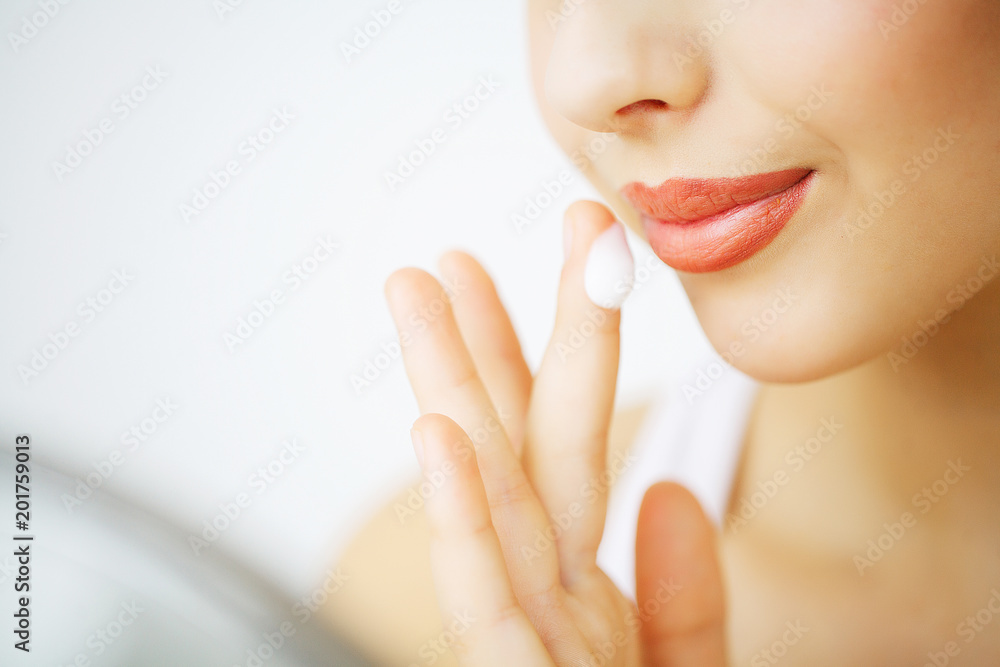 Obraz premium Beauty Face Care. Woman Applying Cream On Skin.