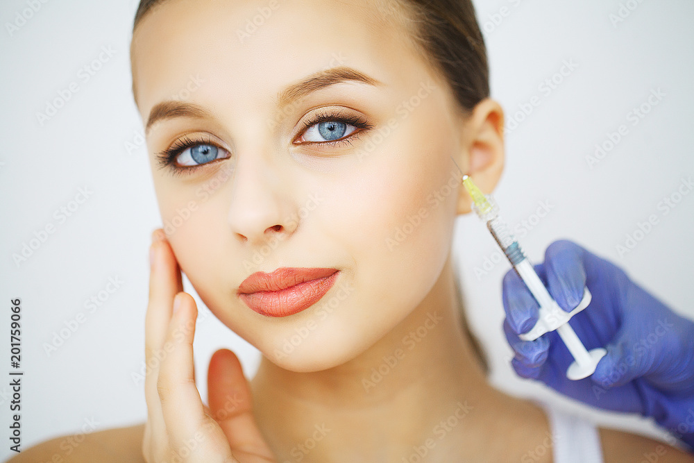 Lips plastic surgery injection on young woman face Lips plastic surgery injection on young woman face