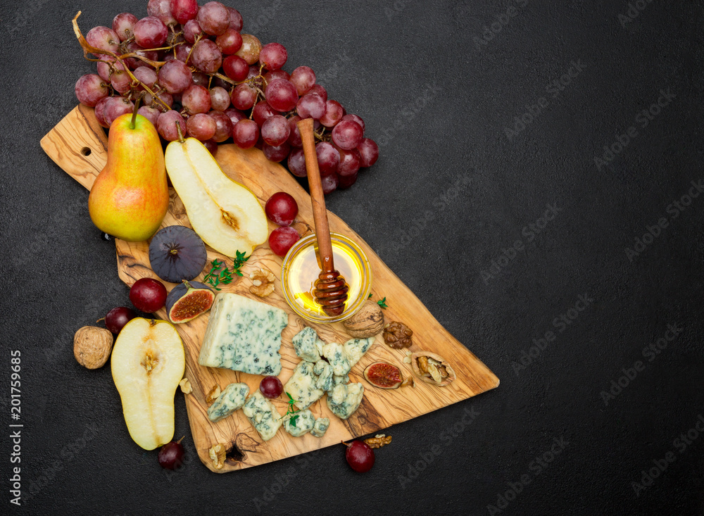 Slice of French Roquefort cheese and pear on wooden board Slice of French Roquefort cheese and pear on wooden board
