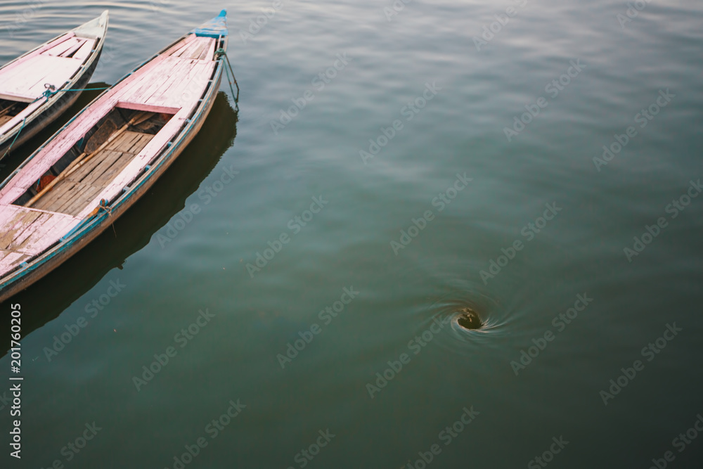Funnel whirlpool in the water of the Ganges river in Varanasi, India.