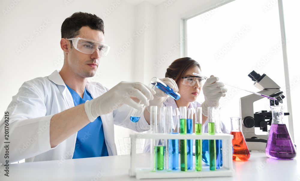 Two scientists are working in laboratory. Two scientists are working in laboratory.