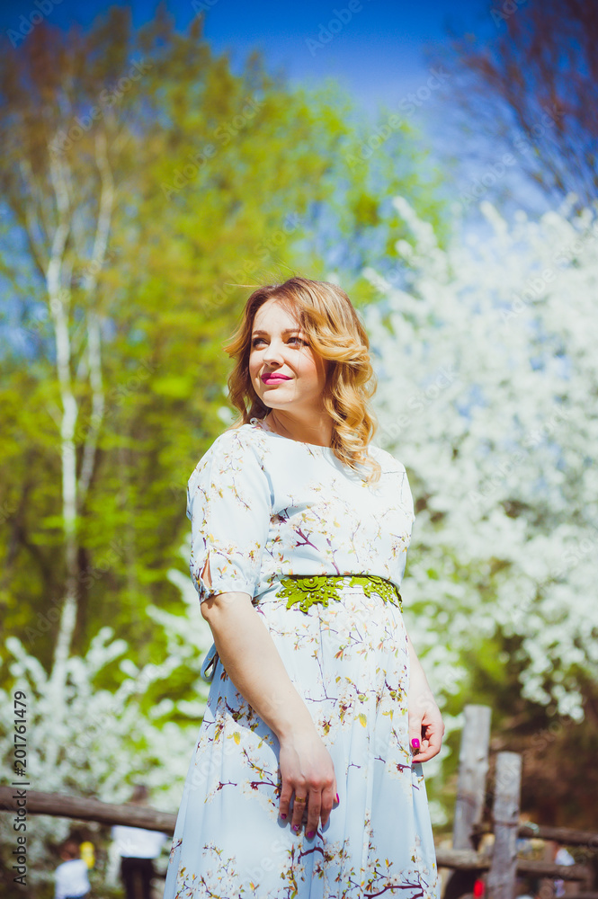 Beautiful blonde pregnant woman walkiing in the park Beautiful blonde pregnant woman walkiing in the park