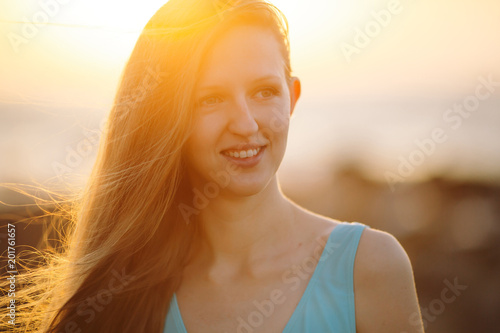 Smiling Woman On the Background from Blue Sea in Sunlight. photo