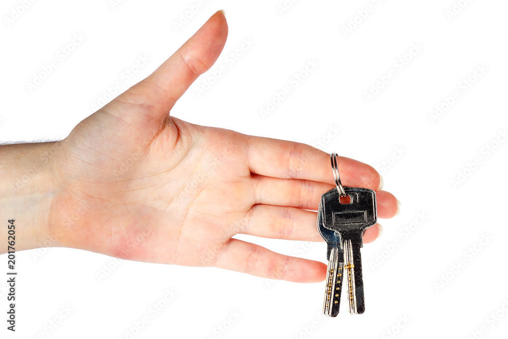 House keys in the female hand on a white background