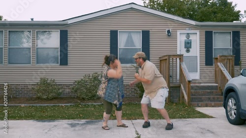 Happy couple saying goodbye, dancing, and running inside of their home