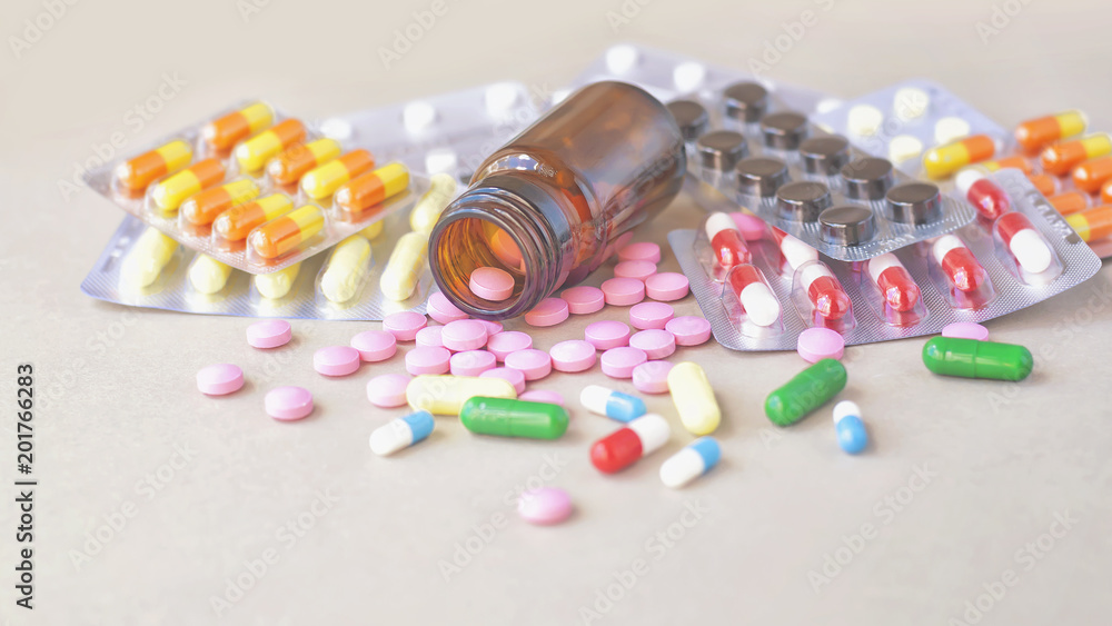 Composition of medicine bottle and pills on gray background. Composition of medicine bottle and pills on gray background.