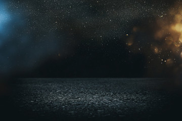 Spotlight on concrete floor. dark black and glowing lights