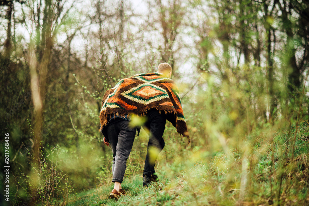 couple is climbing in the mountains covered with rug couple is climbing in the mountains covered with rug