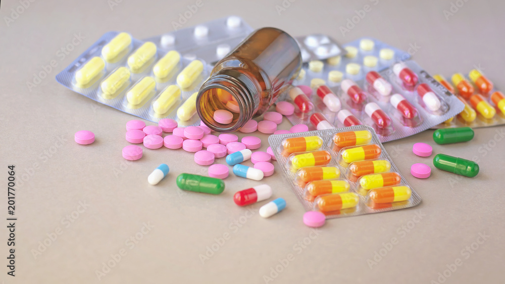 Composition of medicine bottle and pills on gray background. Composition of medicine bottle and pills on gray background.