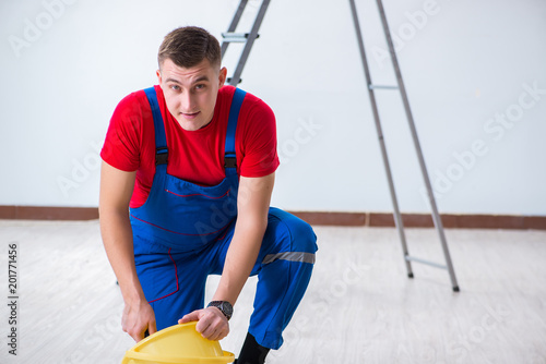 Male painter preparing for painting job at construction site