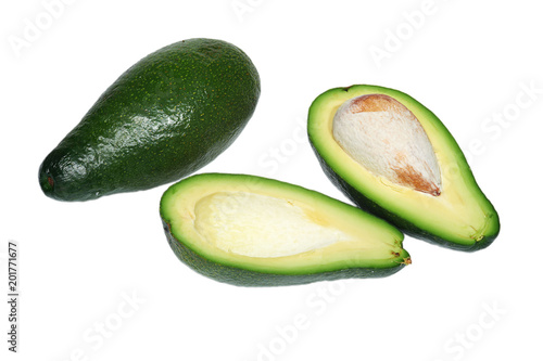 Two avocado, the whole and cut in half with bone on white background, isolated