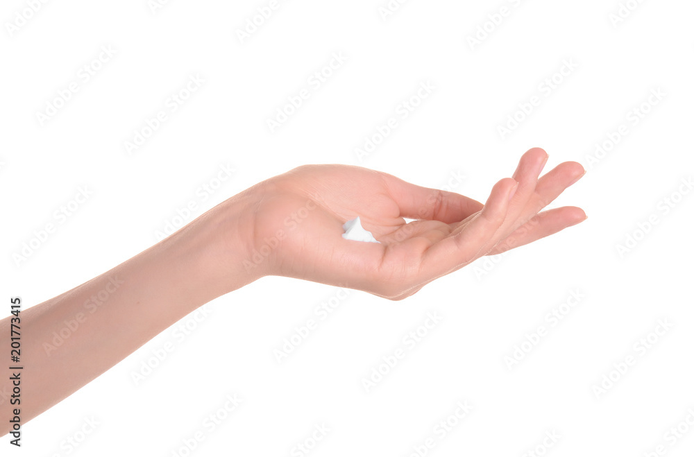 Young woman applying hand cream against on white background Young woman applying hand cream against on white background