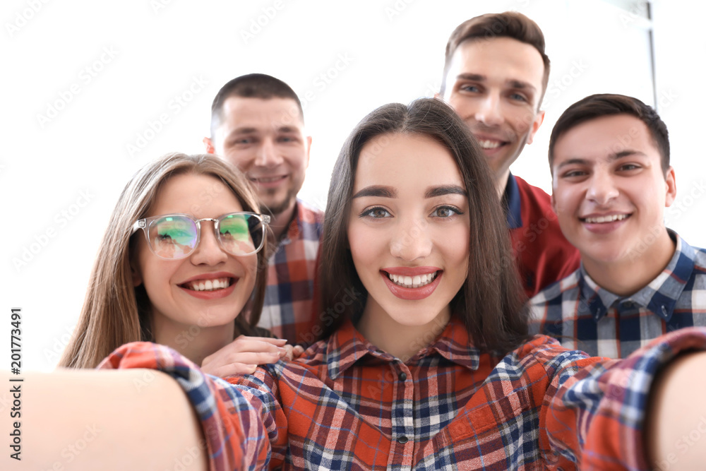 Happy friends taking selfie indoors