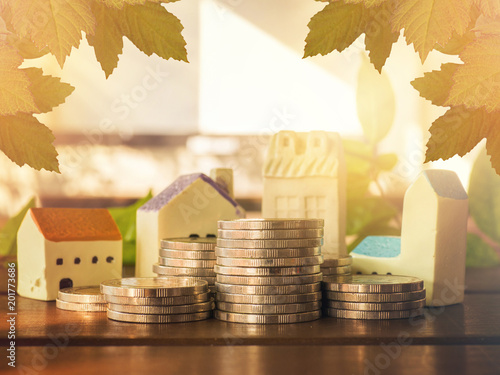 Mortgage concept by money house from the coins,Business Finance and Money concept,Saving concept to buy a house.mortgage loading real estate property with loan money bank concept.