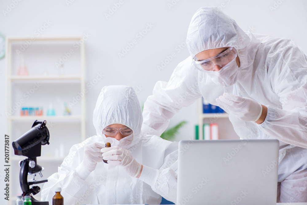 Two scientists working in the chemical lab Two scientists working in the chemical lab