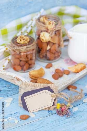 Almonds and jar with milk on the wooden tray