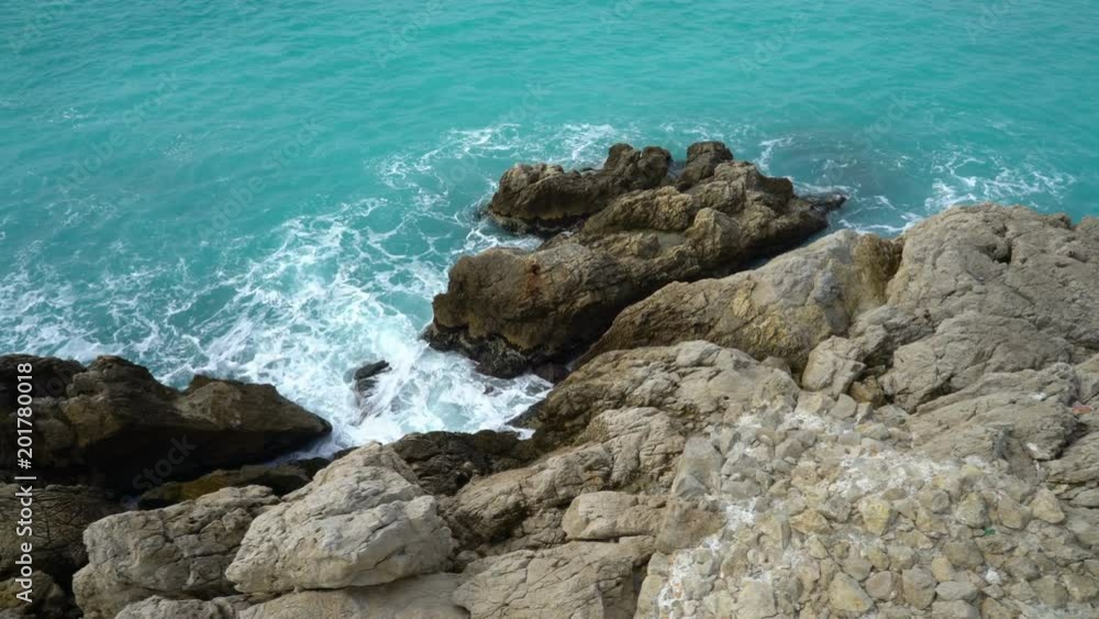 Waves break on the coastal cliffs. Nice, Bay of angels (Baie-des-Anges), Provence, Côte d'azur, France Waves break on the coastal cliffs. Nice, Bay of angels (Baie-des-Anges), Provence, Côte d'azur, France