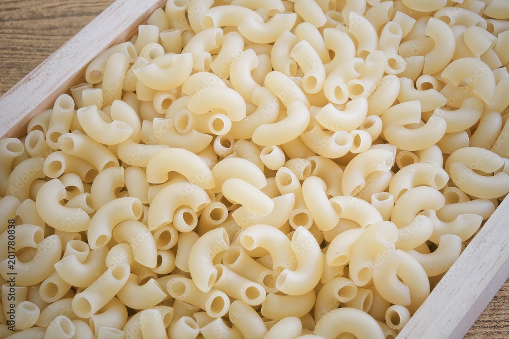 Elbow Macaroni or Gomiti Pasta in Wooden Tray Elbow Macaroni or Gomiti Pasta in Wooden Tray