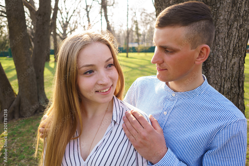 Fototapeta premium Young man hugging his lover woman. Care, love, togetherness conc