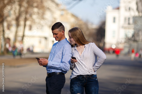 Slika na platnu Jealous girlfriend spying her boyfriend messaging