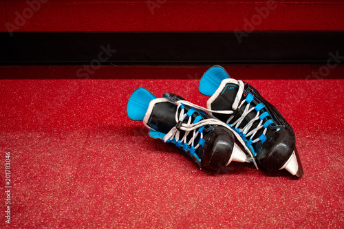 Kids hockey skates, lying in locker room floor with copy space  © MCRMfotos