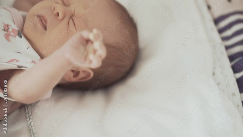 Cute Newborn Baby in Crib Looking at Camera. Close up. Family concept Cute Newborn Baby in Crib Looking at Camera. Close up. Family concept