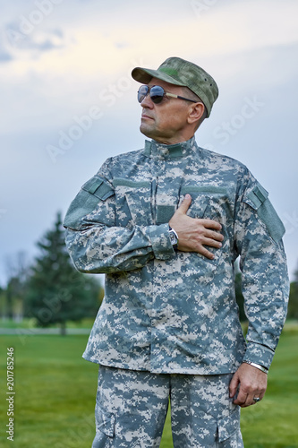 Patriotic soldier in uniform outdoors. Portrait of brave patriotic sergeant with sunglasses.